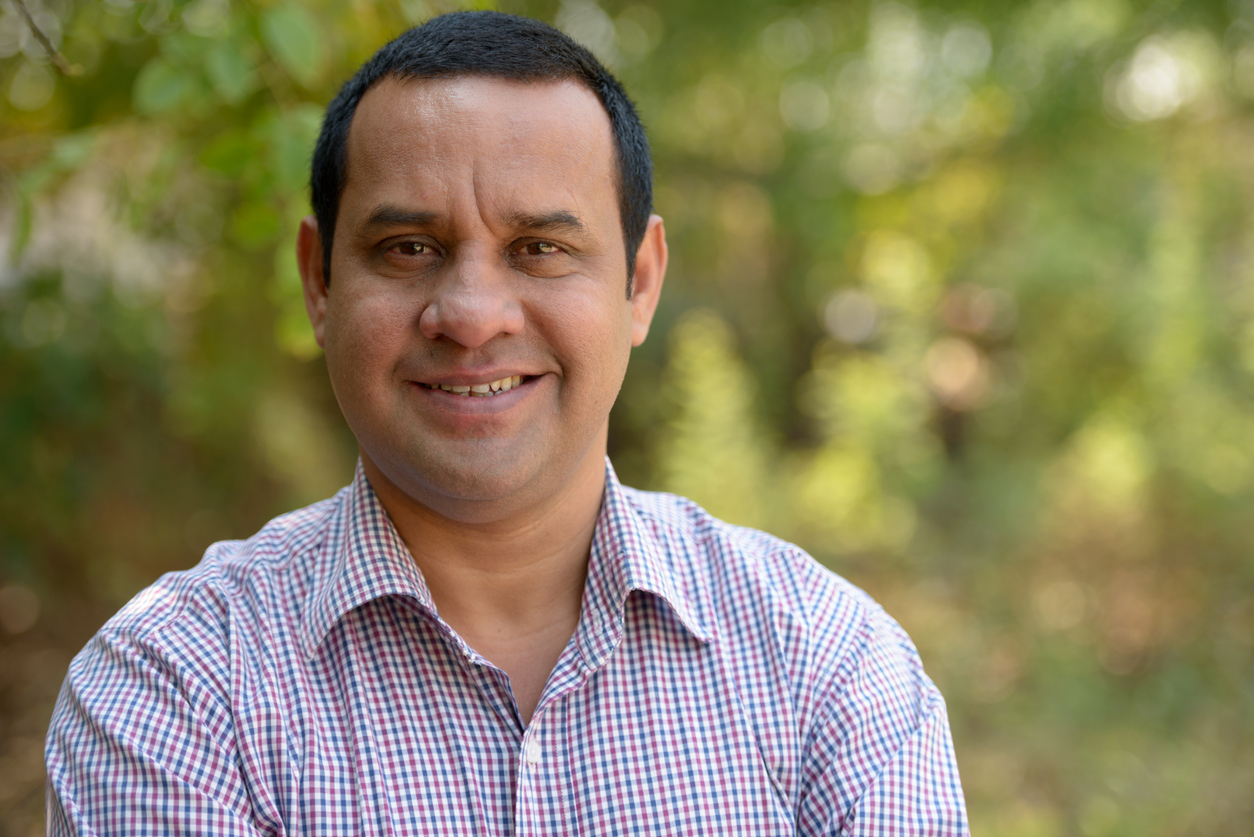 Portrait of Indian man smiling outdoors horizontal shot